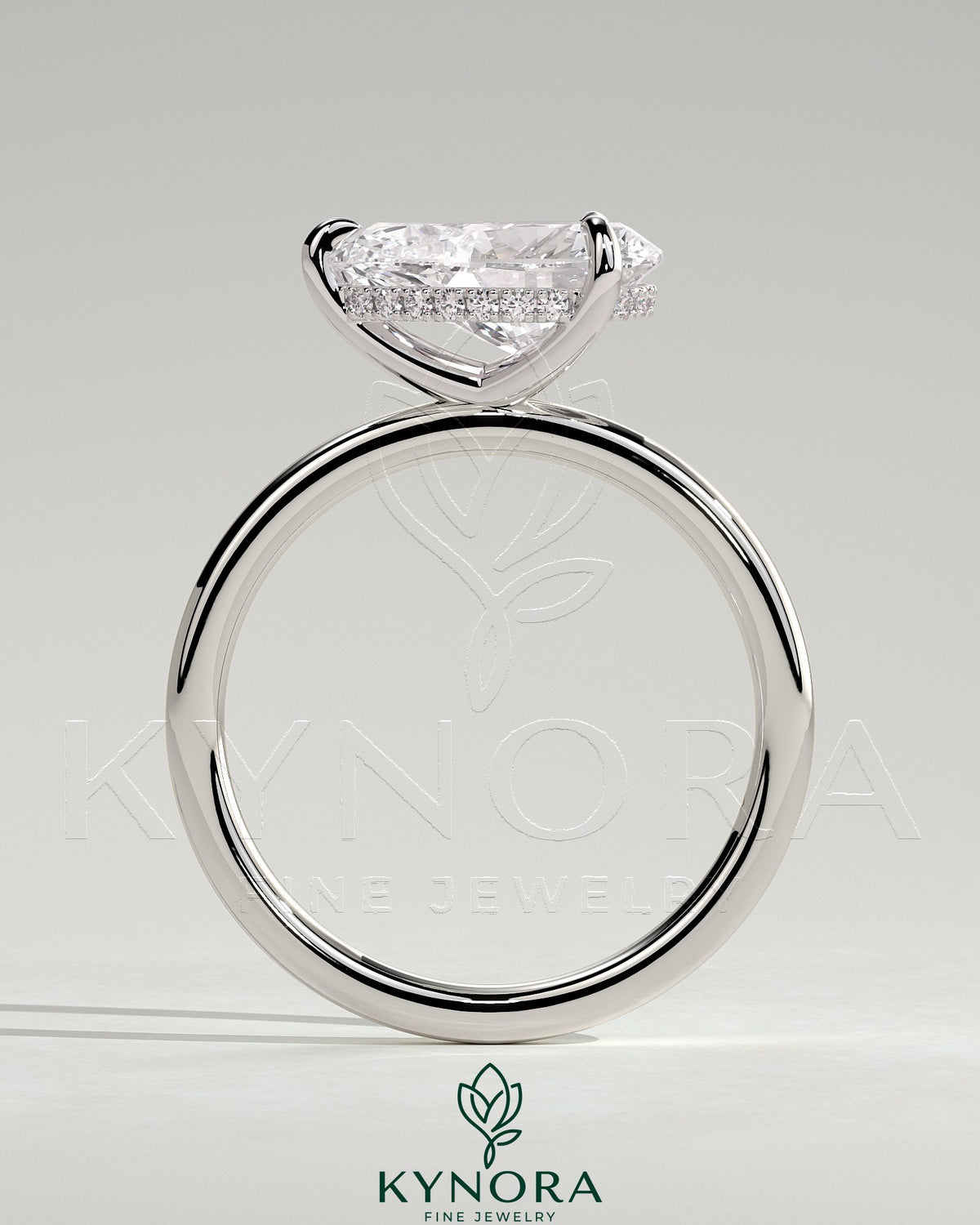 Kynora CJ 2ct pear-shaped east-west claw solitaire engagement ring with hidden halo and sparkling diamond accents.