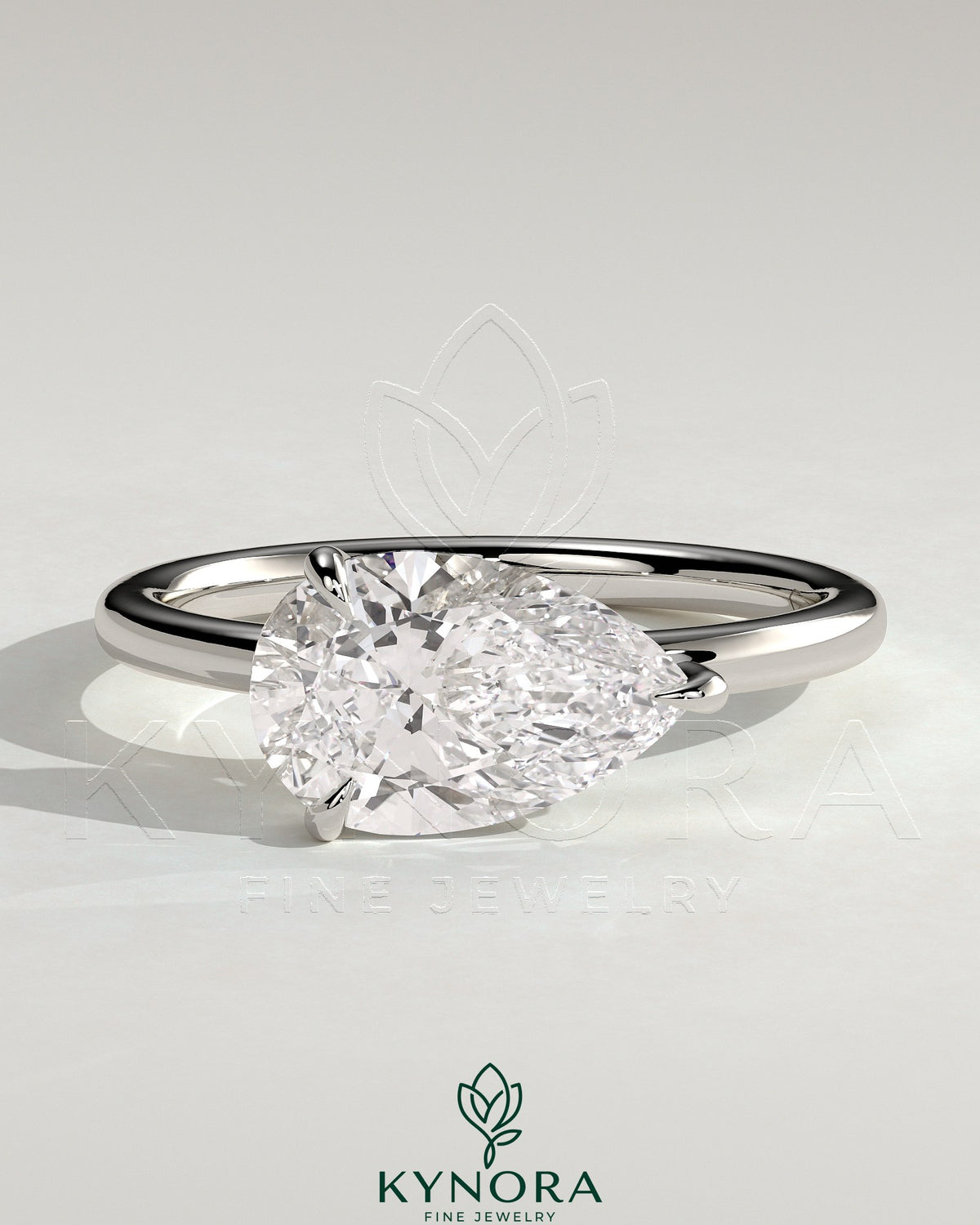 Kynora CJ 2ct pear-shaped east-west claw solitaire engagement ring with raised basket gallery setting. Main image