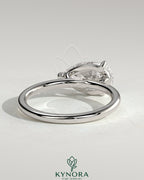Kynora CJ 2ct pear-shaped east-west claw solitaire engagement ring with raised basket gallery and diamond setting.