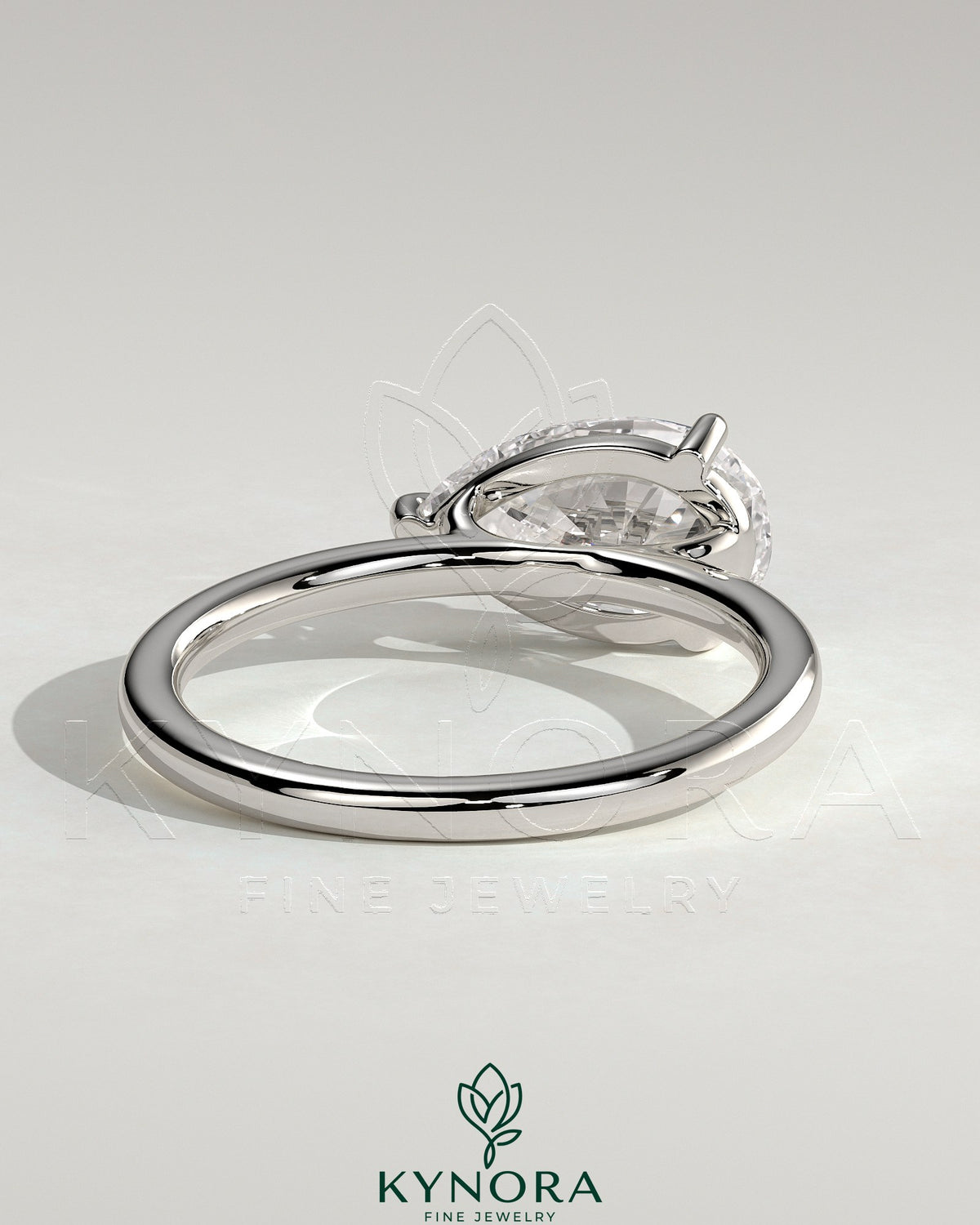 Kynora CJ 2ct pear-shaped east-west claw solitaire engagement ring with raised basket gallery and diamond setting.