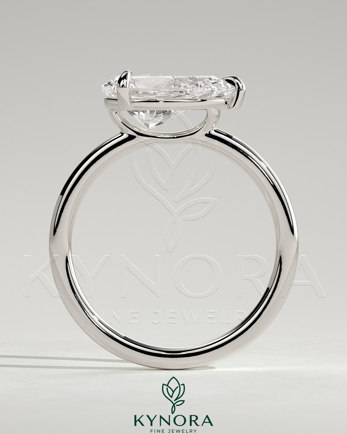 Kynora CJ 2ct pear-shaped east-west claw solitaire engagement ring with raised basket gallery in silver or gold metal.