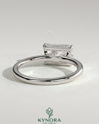 Kynora CJ 2ct radiant east-west claw solitaire engagement ring with raised basket gallery design and sparkling diamond centerpiece.