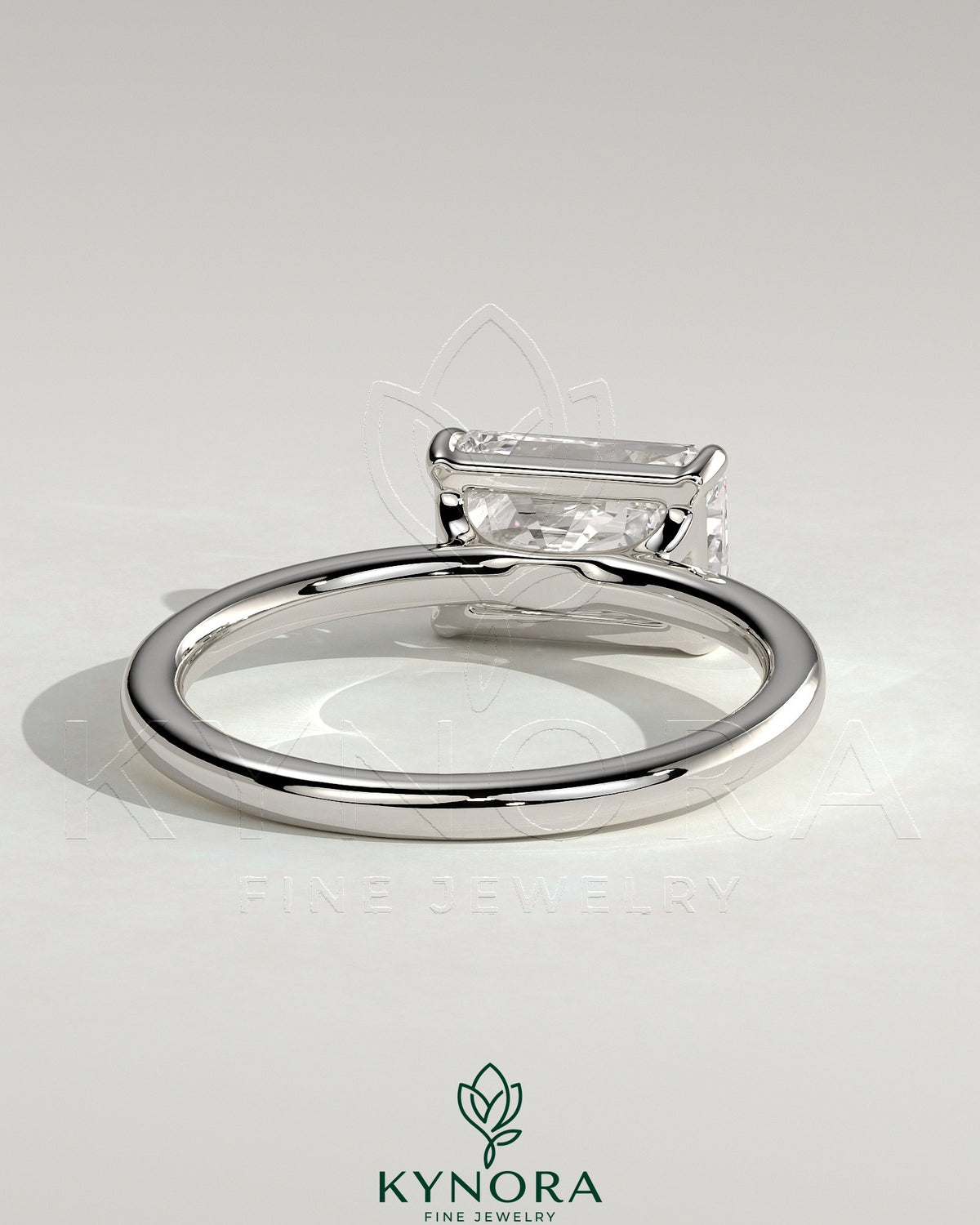Kynora CJ 2ct radiant east-west claw solitaire engagement ring with raised basket gallery design and sparkling diamond centerpiece.