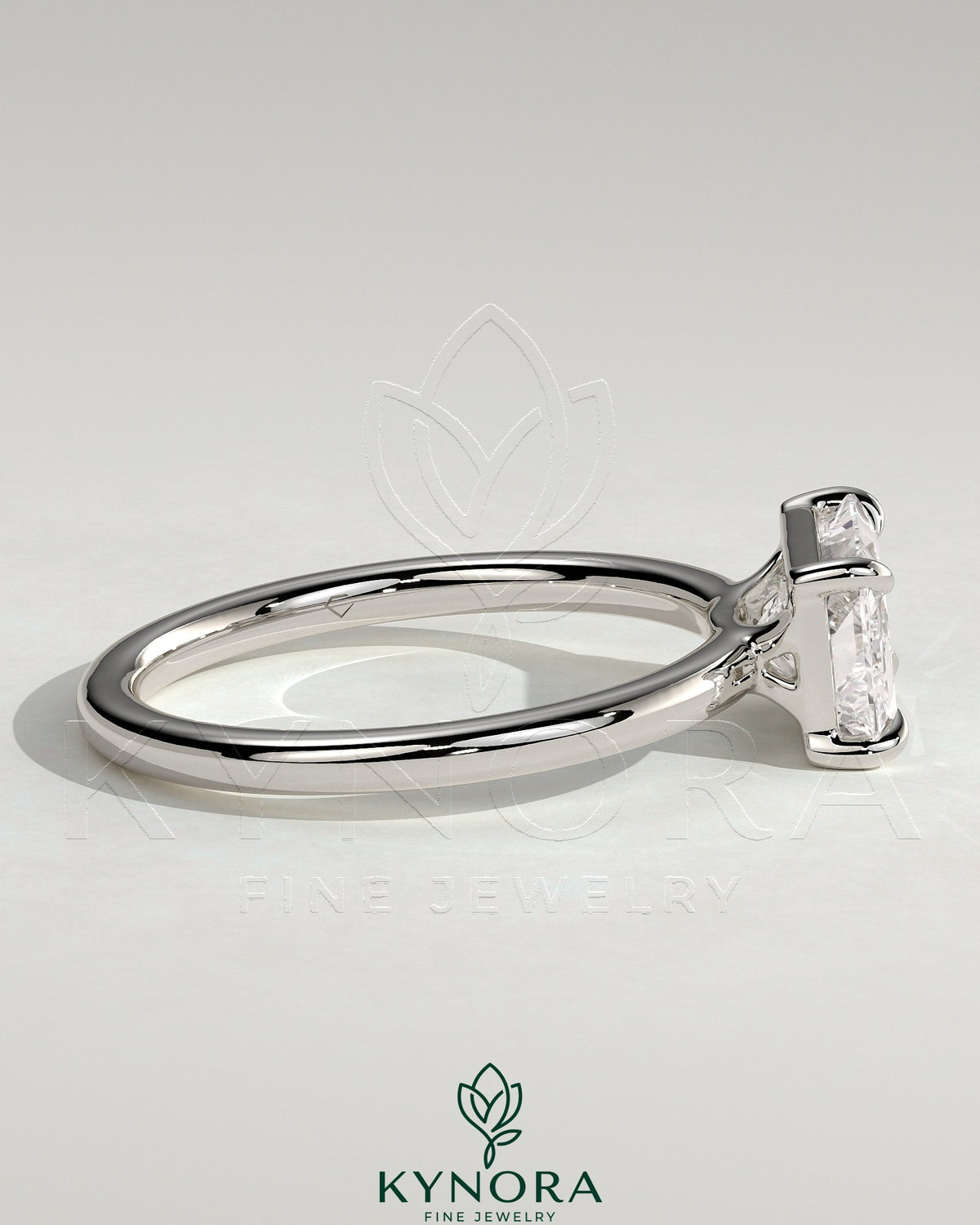 Kynora CJ 2ct radiant east-west claw solitaire engagement ring with raised basket gallery, showcasing a sparkling central diamond.
