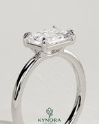Kynora CJ 2ct radiant east-west claw solitaire engagement ring with raised basket gallery design, sparkling center stone.