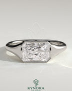 Kynora CJ Radiant East-West Bezel Solitaire engagement ring with signet band, showcasing a radiant-cut center stone and elegant design.