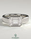 Kynora CJ statement 2ct emerald east-west bezel solitaire engagement ring with flat cigar band, featuring a prominent green emerald gemstone.