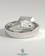 Kynora CJ statement 2ct emerald east-west bezel solitaire engagement ring with flat cigar band showcasing a vibrant green emerald.