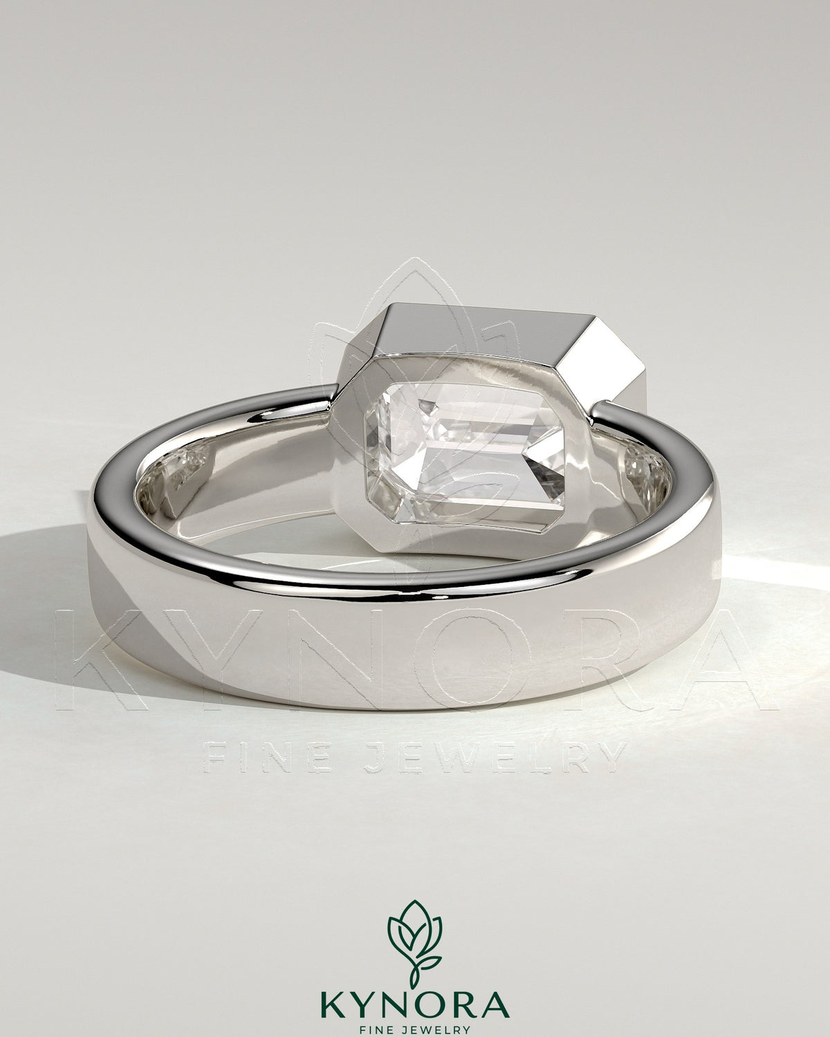 Kynora CJ statement 2ct emerald east-west bezel solitaire engagement ring with flat cigar band showcasing a vibrant green emerald.