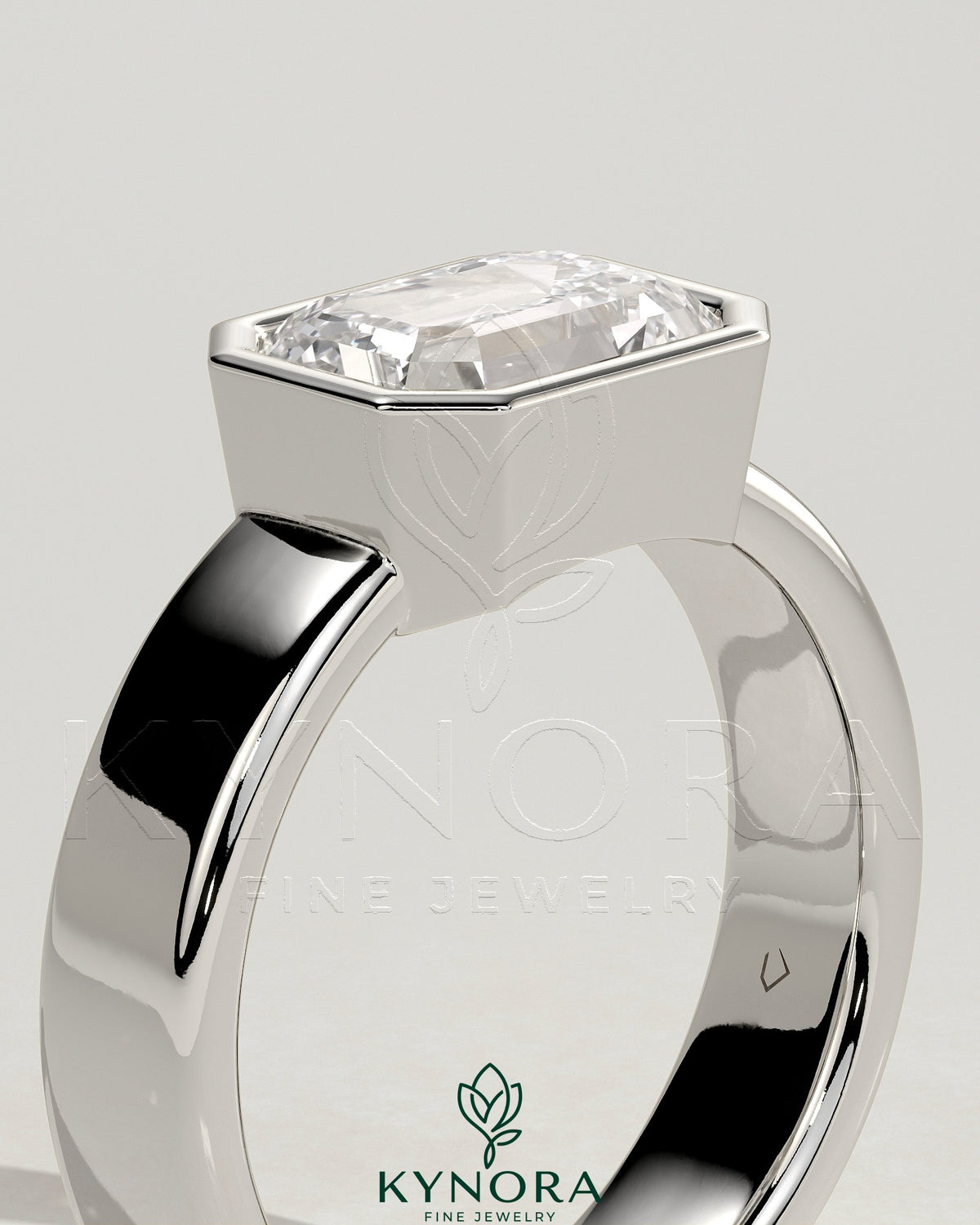 Kynora CJ emerald east-west bezel solitaire engagement ring with a 2-carat emerald and flat cigar band.