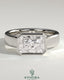 Kynora CJ radiant 2ct east-west bezel solitaire engagement ring with flat cigar band, featuring sparkling center stone and sleek design.