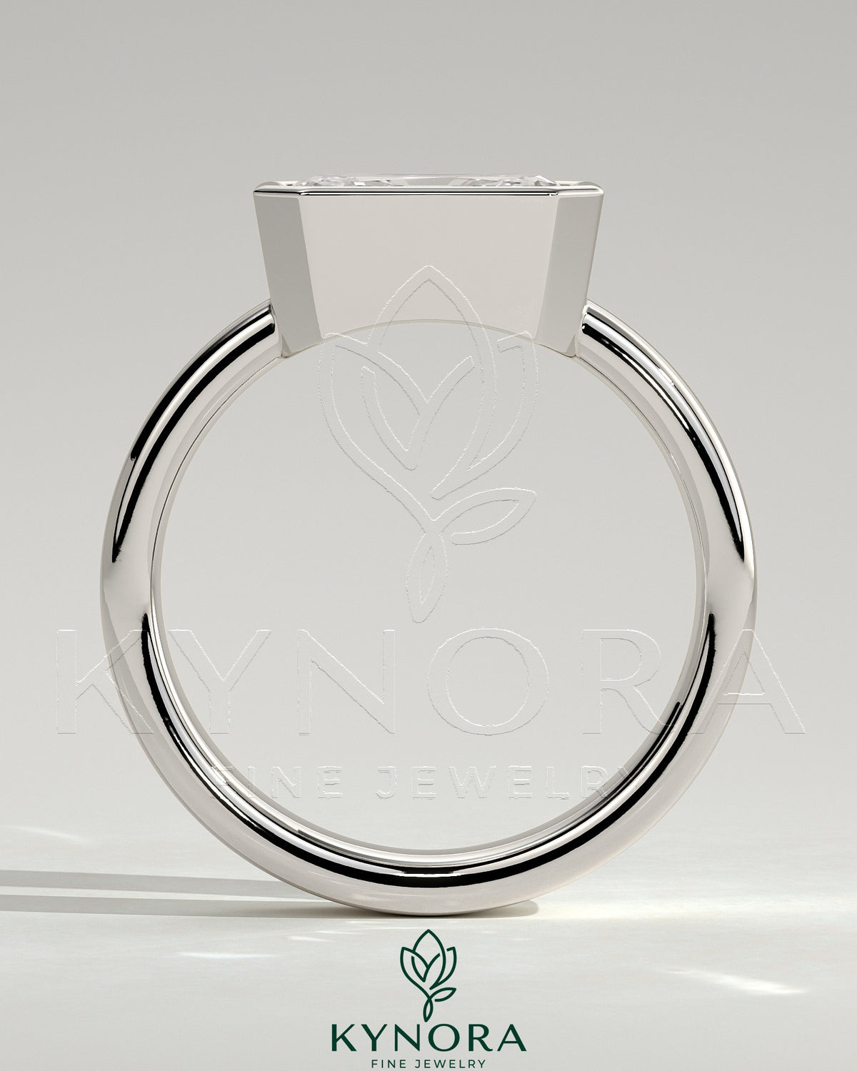 Kynora CJ East-West 2ct radiant diamond bezel solitaire engagement ring with flat cigar band, showcasing elegant jewelry design.