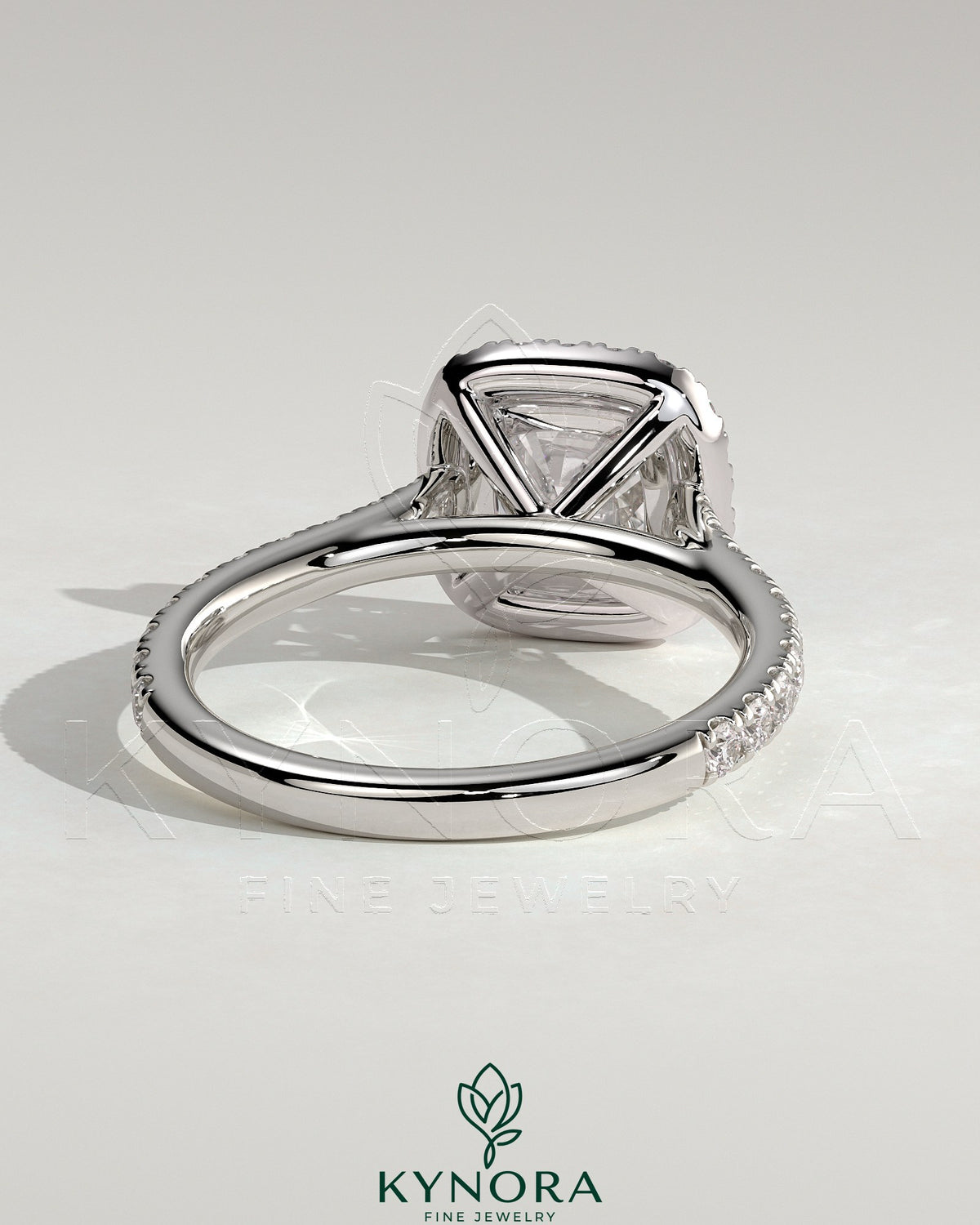 Kynora CJ 2ct cushion claw solitaire engagement ring with halo, pave band, and cathedral high setting in elegant jewelry style