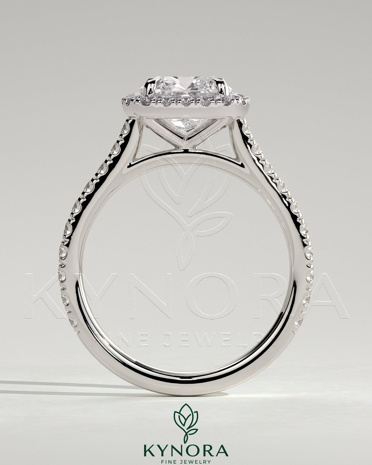 Kynora CJ 2ct cushion claw solitaire engagement ring with halo, pave band, and cathedral high setting, crafted in elegant jewelry design.
