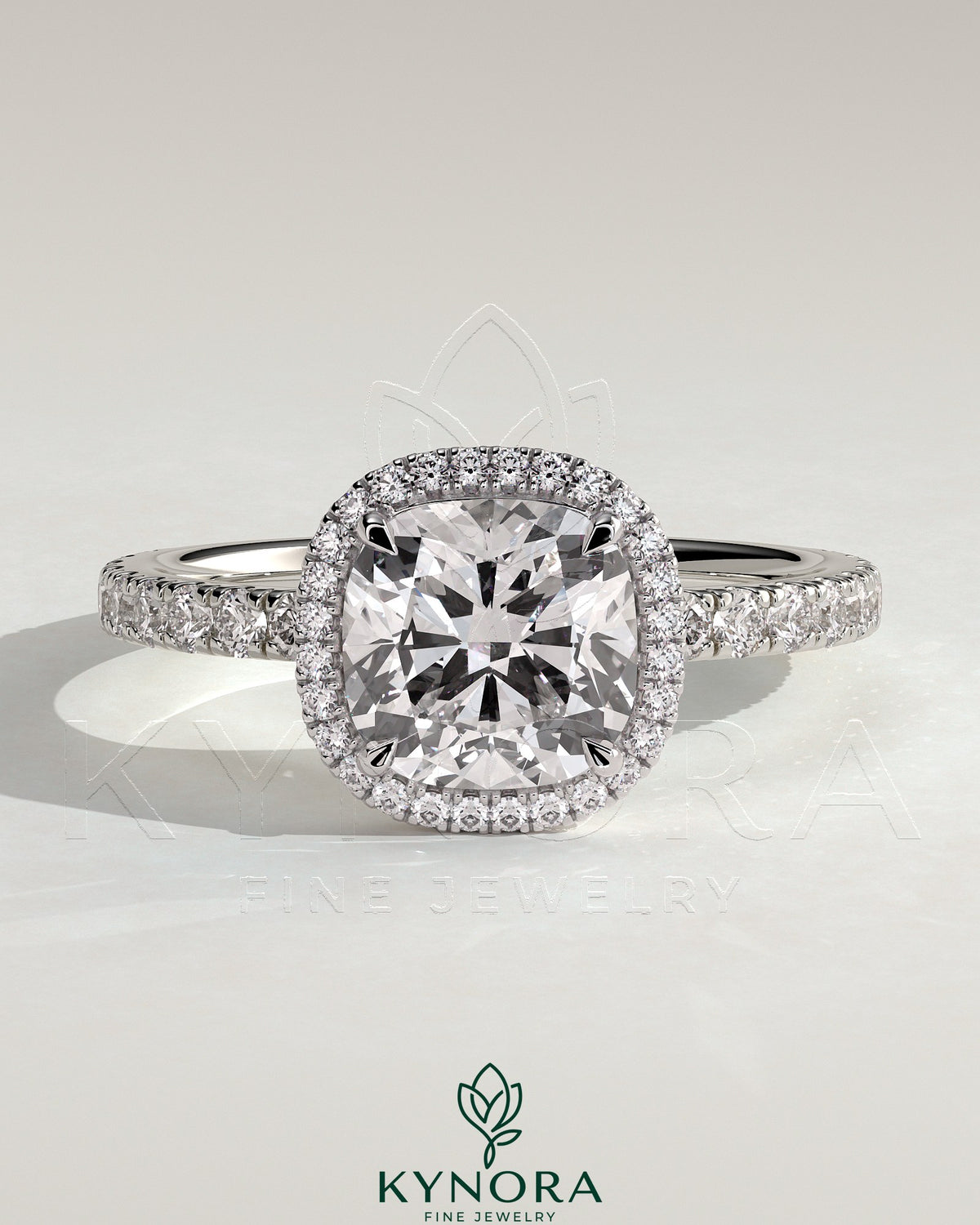 Kynora CJ 2ct cushion cut halo engagement ring with pave band and claw setting, featuring sparkling diamonds.