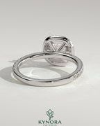 Kynora CJ 2ct cushion claw solitaire engagement ring with halo and pave band, featuring sparkling diamond details.