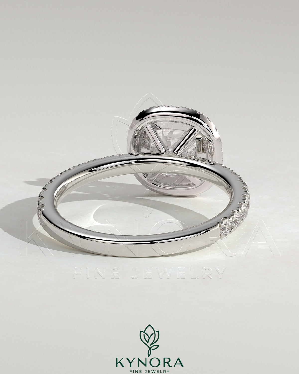 Kynora CJ 2ct cushion claw solitaire engagement ring with halo and pave band, featuring sparkling diamond details.