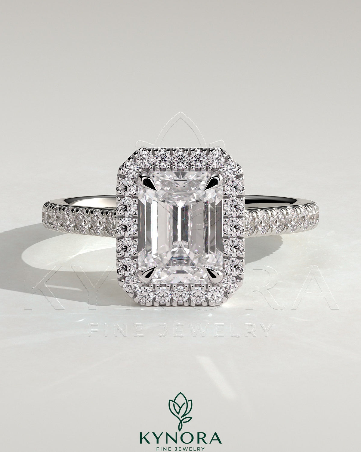 Kynora CJ 2ct emerald claw solitaire engagement ring with halo, pave band, and cathedral high setting showcasing the detailed design.