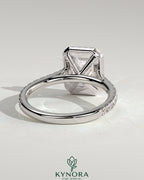 Kynora CJ 2ct emerald claw solitaire engagement ring with halo, pave band, and cathedral high setting.