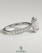 Kynora CJ 2ct emerald claw solitaire engagement ring with halo and pave band, showcasing sparkling diamonds and intricate design.
