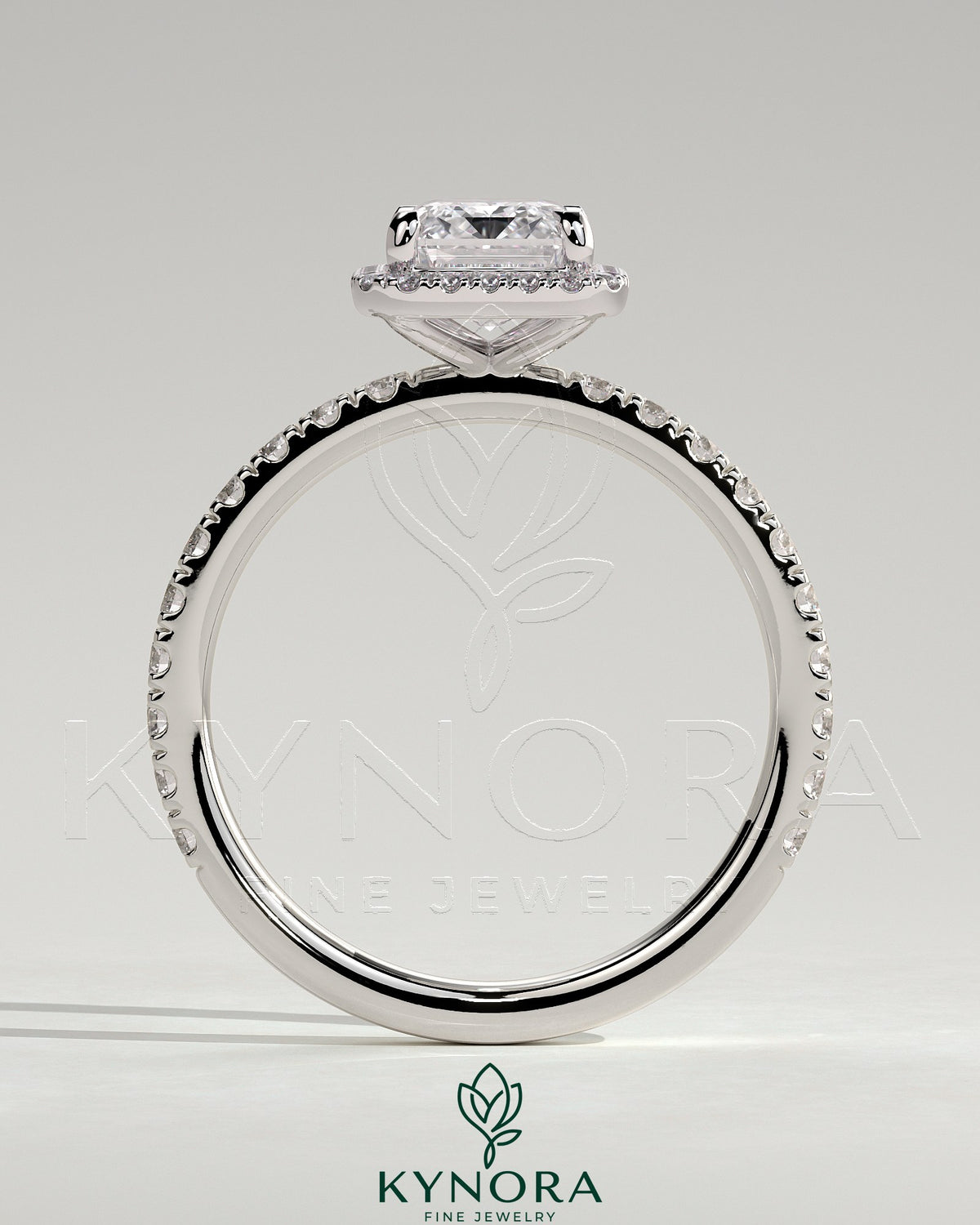 Kynora CJ 2ct emerald claw solitaire engagement ring with halo and pave band, showcasing sparkling center stone and detailed design.