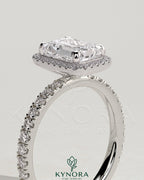 Kynora CJ 2ct emerald claw solitaire engagement ring with halo and pave band, showcasing sparkling emerald center stone and intricate setting.