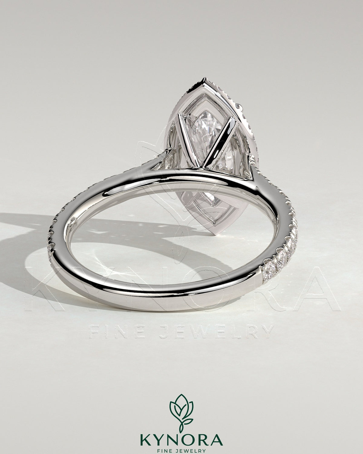 Kynora CJ 2ct marquise claw solitaire engagement ring with halo, pave band, and cathedral high setting.