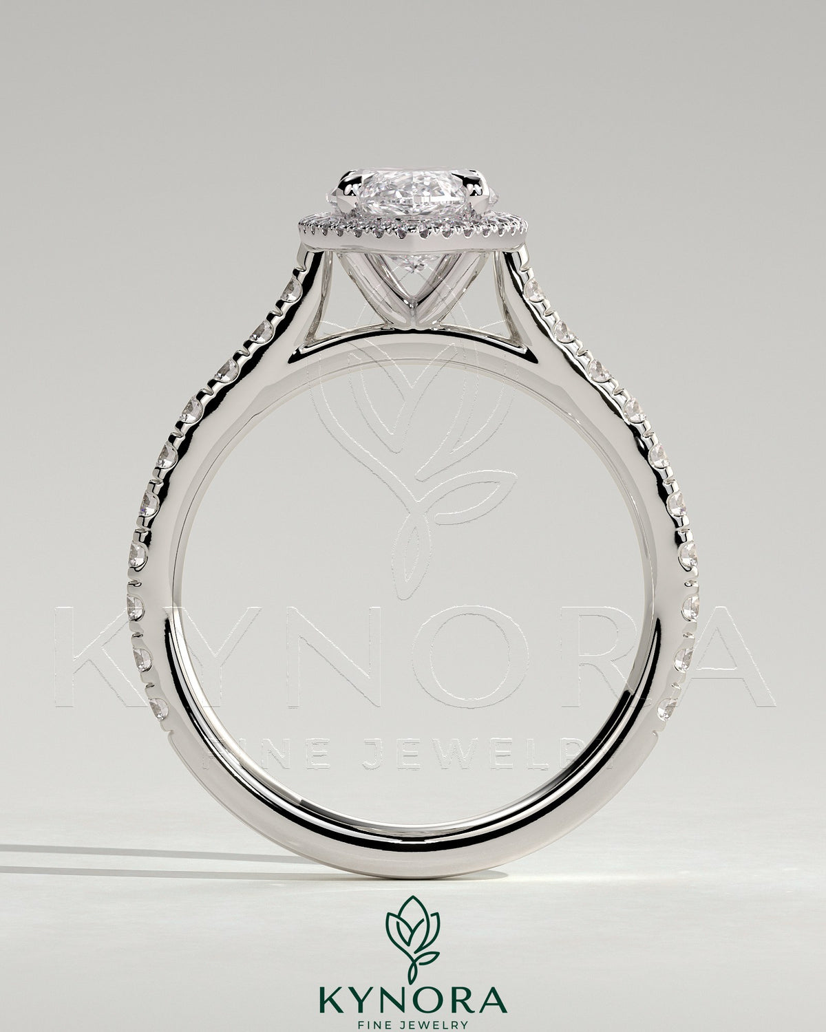 Kynora CJ 2ct marquise claw solitaire engagement ring with halo, pave band, and cathedral high setting on a jewelry display