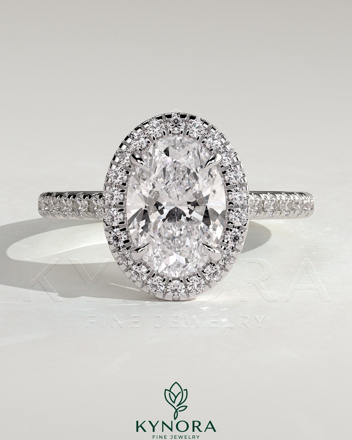 Kynora CJ 2ct oval claw solitaire engagement ring with halo, pave band, and cathedral high setting showcasing detailed craftsmanship. Imagen principal del producto