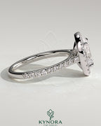 Kynora CJ 2ct oval claw solitaire engagement ring with halo, pave band, and cathedral high setting showcasing intricate design.