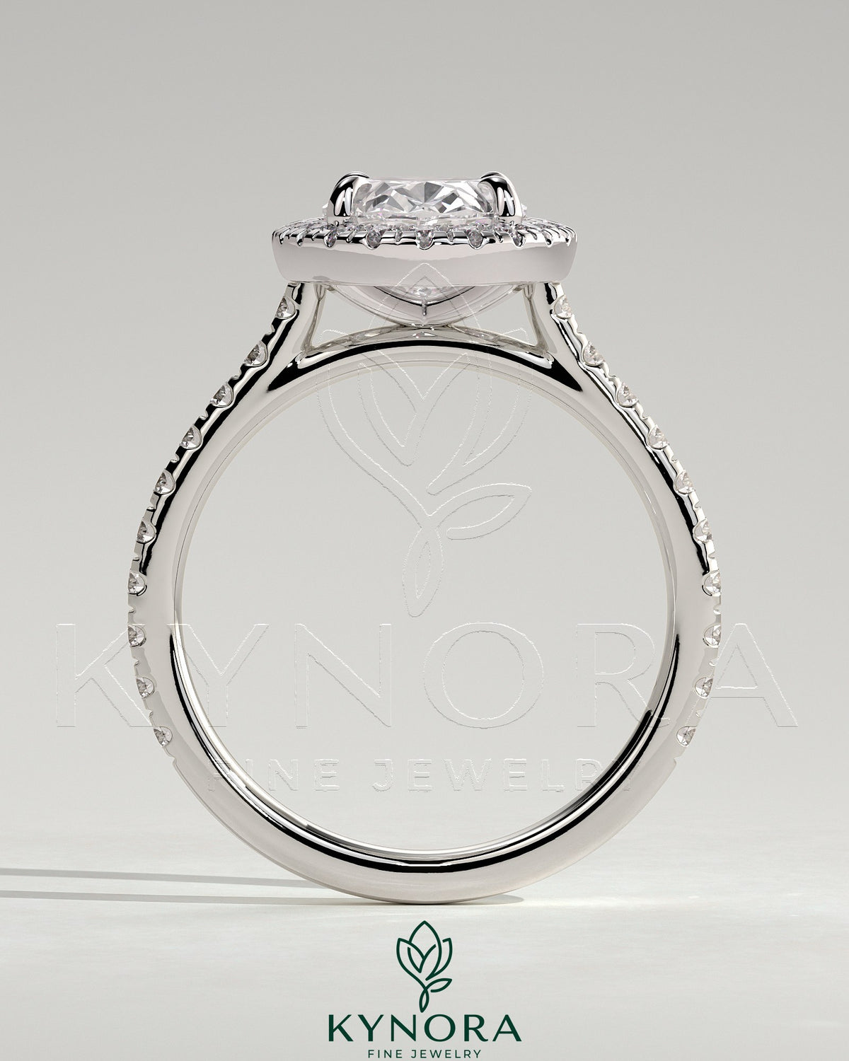 Kynora CJ 2ct oval claw solitaire engagement ring with halo, pave band, and cathedral high setting, showcasing intricate design details.