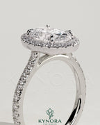 Kynora CJ 2ct oval claw solitaire engagement ring with halo, pave band, and cathedral high setting showcasing sparkling diamond details