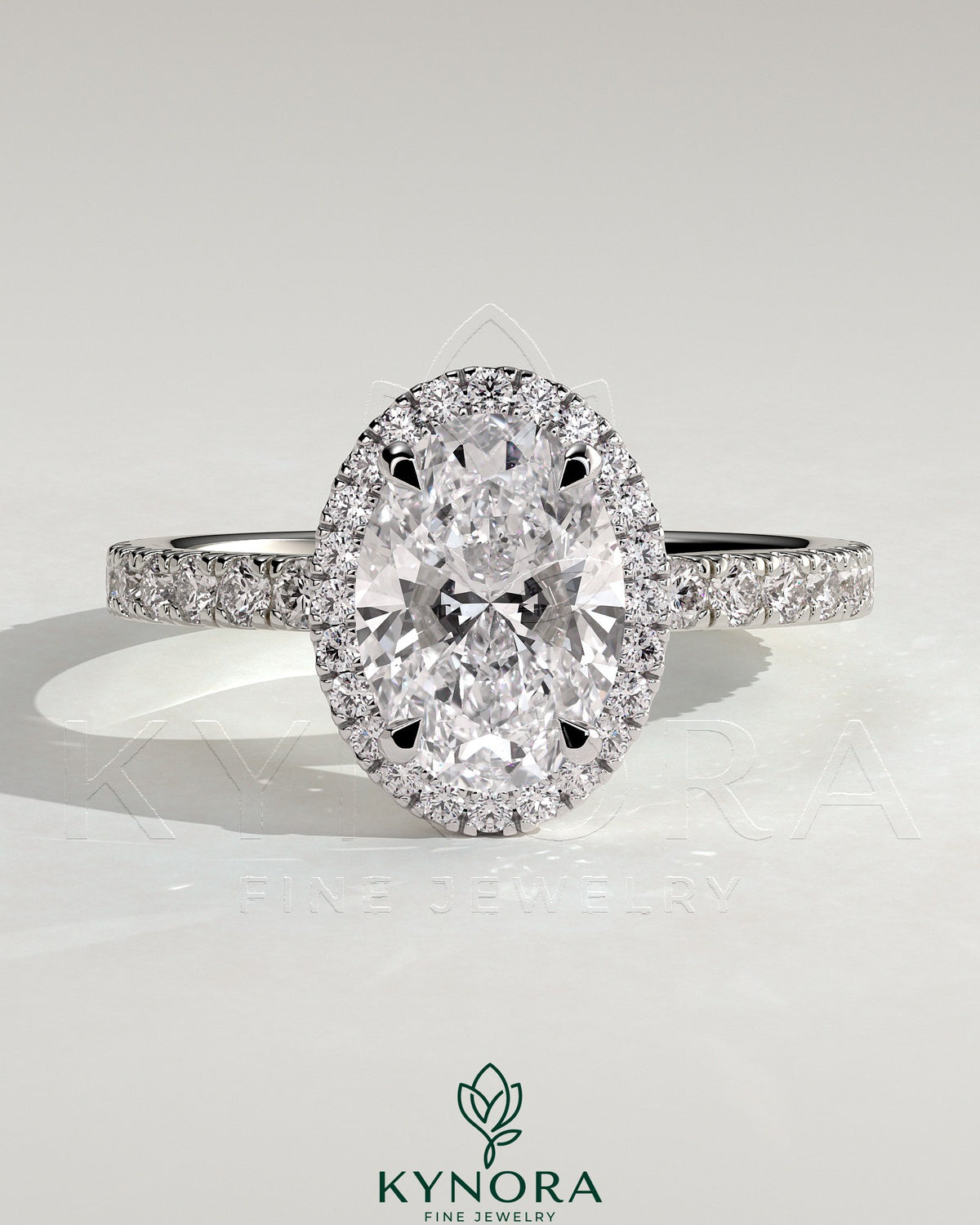 Kynora CJ 2ct oval claw solitaire engagement ring with halo and pave band, showcasing sparkling diamond details. Imagen principal del producto