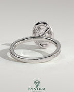 Kynora CJ 2ct oval claw solitaire engagement ring with halo and pave band, showcasing sparkling diamond details.