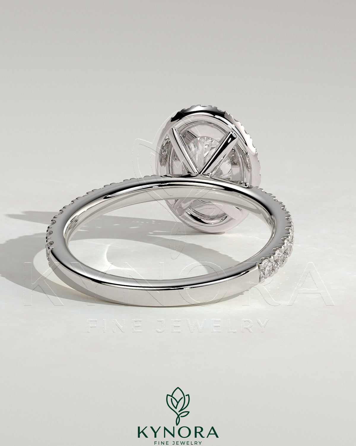Kynora CJ 2ct oval claw solitaire engagement ring with halo and pave band, showcasing sparkling diamond details.