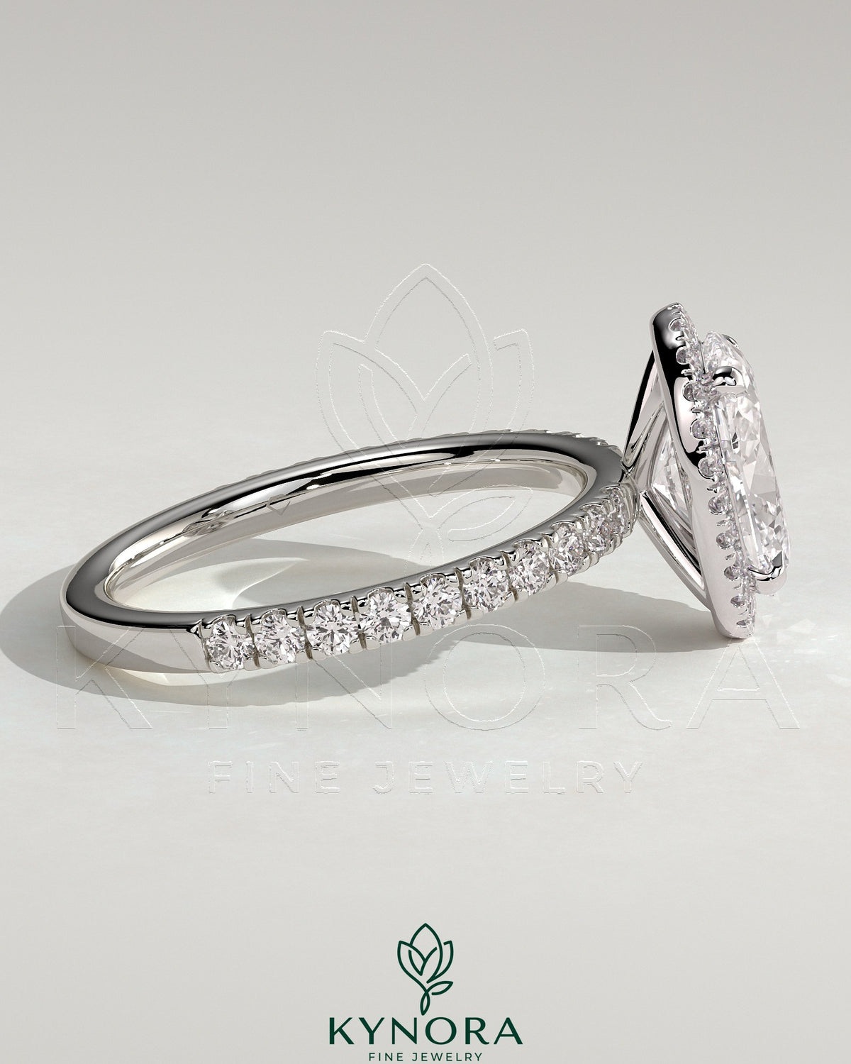 Kynora CJ 2ct oval claw solitaire engagement ring with halo and pave band in sterling silver, detailed close-up of sparkling design.