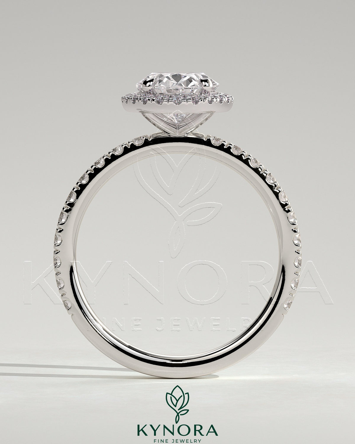 Kynora CJ 2ct oval claw solitaire engagement ring with halo and pave band showcasing a sparkling center stone and detailed band design