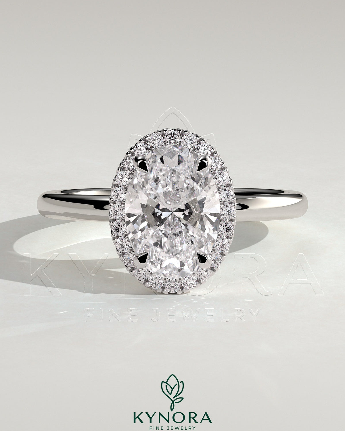 Kynora CJ 2ct oval claw solitaire engagement ring with halo of smaller diamonds, showcasing elegant design and sparkling center stone.