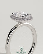 Kynora CJ 2ct oval claw solitaire halo engagement ring featuring a central oval diamond with a surrounding halo setting.
