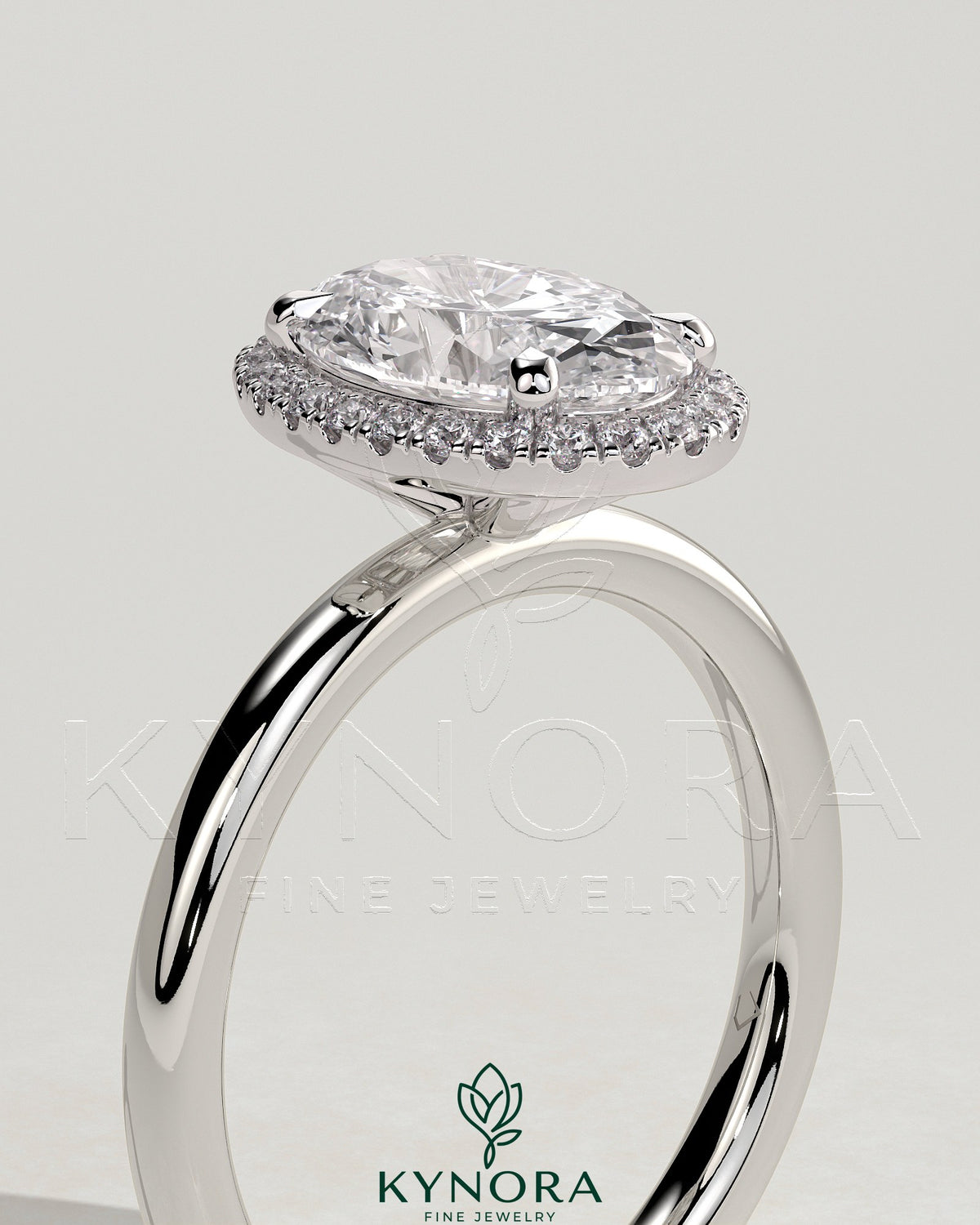 Kynora CJ 2ct oval claw solitaire halo engagement ring featuring a central oval diamond with a surrounding halo setting.