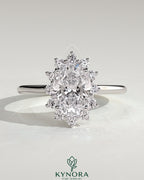 Kynora CJ 2ct oval claw solitaire engagement ring with sunburst halo and cathedral high setting, showcasing sparkling diamond details.