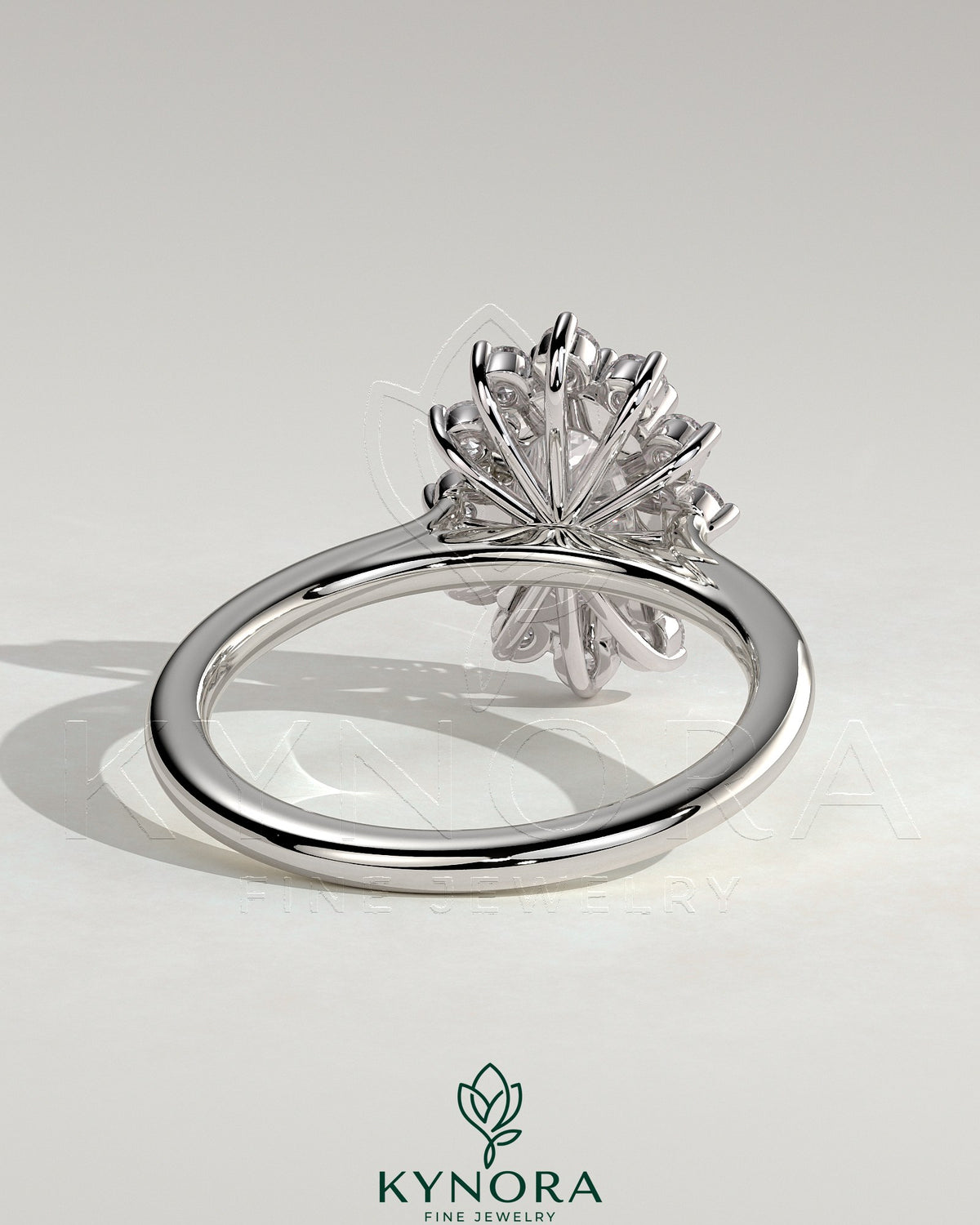 Kynora CJ 2ct oval claw solitaire engagement ring with sunburst halo and cathedral high setting, showcasing intricate design details.