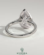 Kynora CJ 2ct pear-shaped diamond engagement ring with halo, pave band, and cathedral high setting showcasing intricate details.