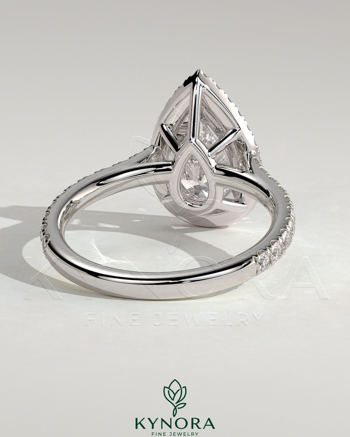 Kynora CJ 2ct pear-shaped diamond engagement ring with halo, pave band, and cathedral high setting showcasing intricate details.