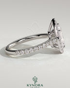 Kynora CJ 2ct pear-shaped diamond solitaire engagement ring with halo, pave band, and cathedral high setting.