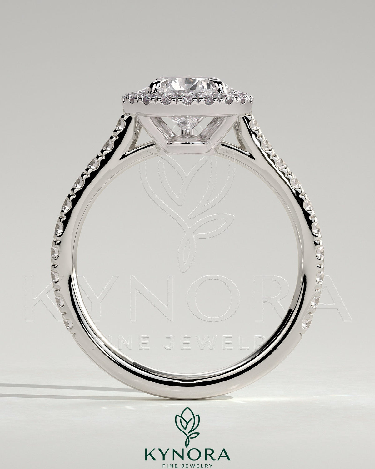Kynora CJ 2ct pear-shaped diamond solitaire engagement ring with halo, pave band, and cathedral high setting.