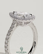 Kynora CJ 2ct pear-shaped diamond solitaire engagement ring with halo, pave band, and cathedral high setting displayed close-up.
