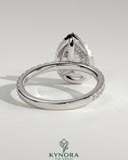 Kynora CJ 2ct pear-shaped diamond halo engagement ring with pave band showcasing sparkling jewelry design.
