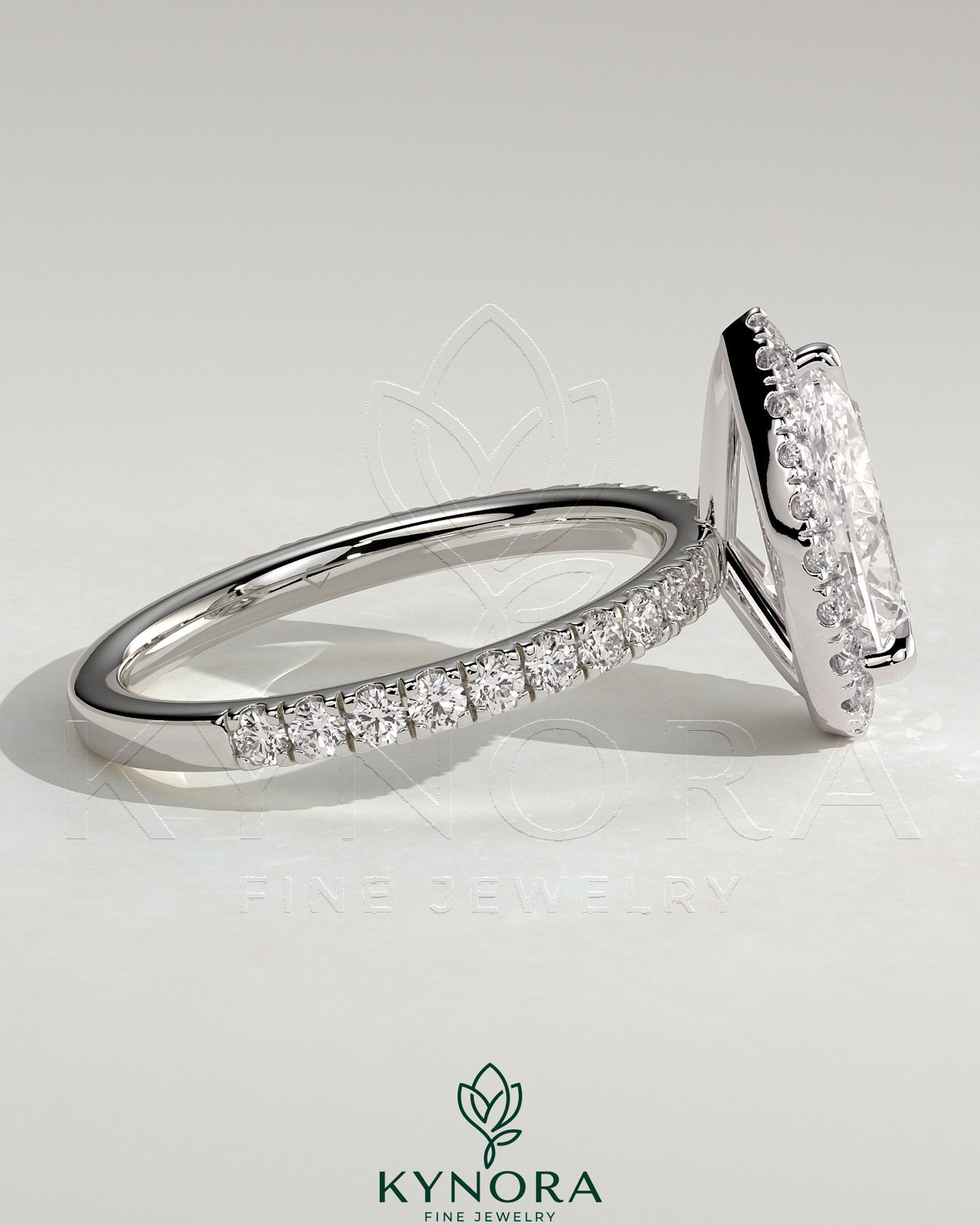 Kynora CJ 2ct pear-shaped diamond halo engagement ring with pave band and intricate setting, showcasing elegant jewelry craftsmanship.