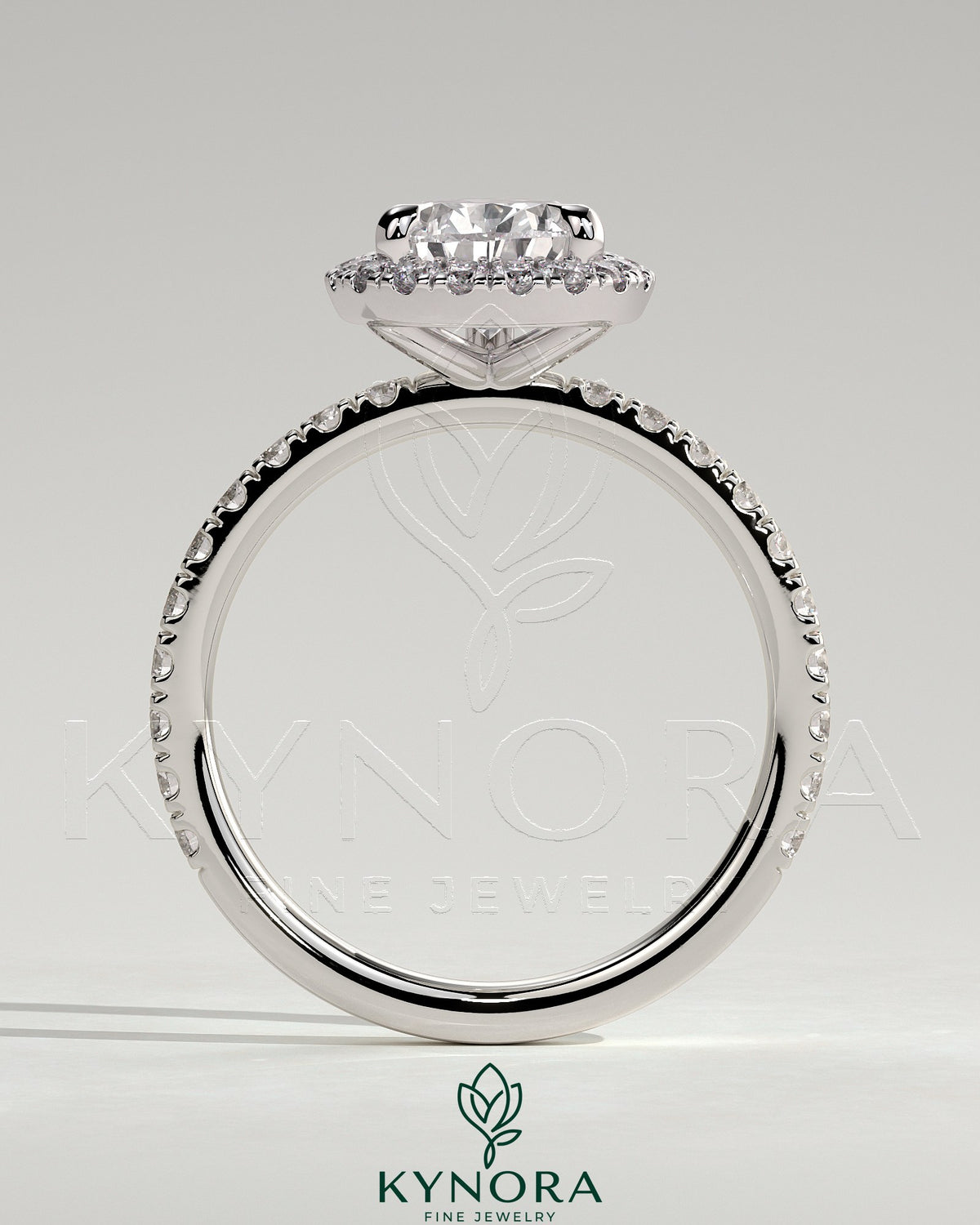 Kynora CJ 2ct pear-shaped diamond solitaire engagement ring with halo and pave band in elegant jewelry design.